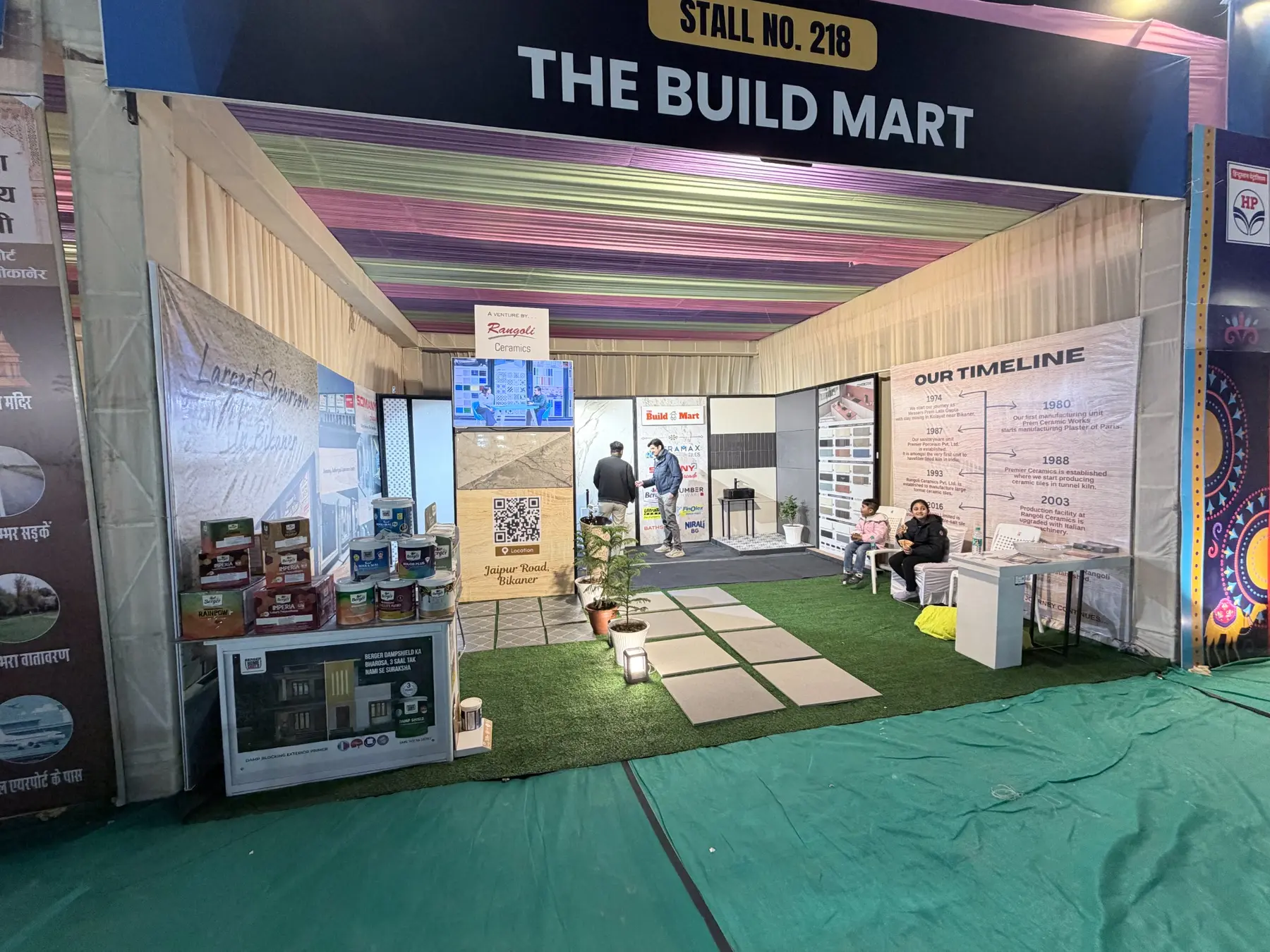Interior of The Build Mart trade fair stall with product displays and company journey panels