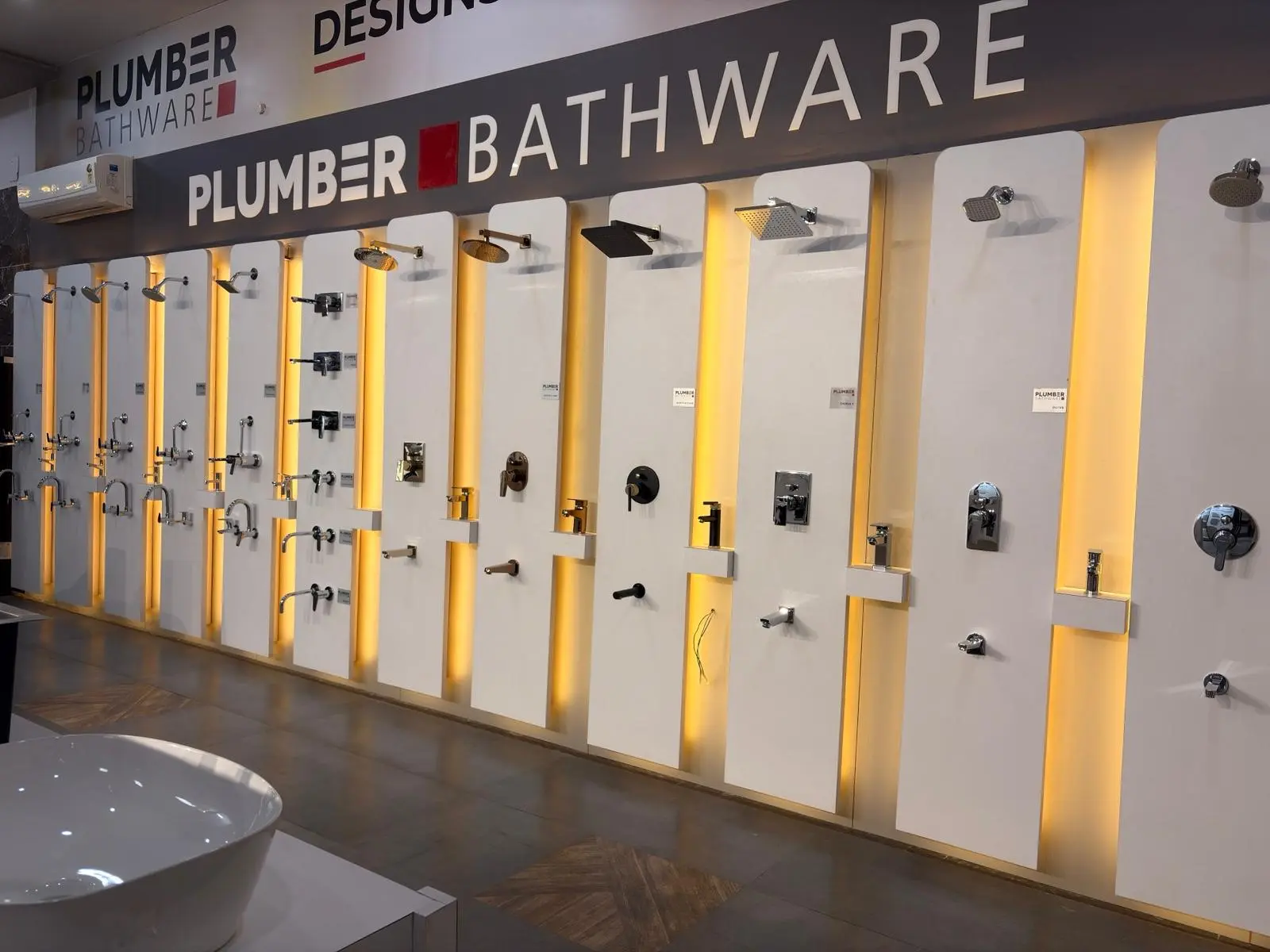 Illuminated Plumber Bathware CP fittings display wall at The Build Mart Bikaner