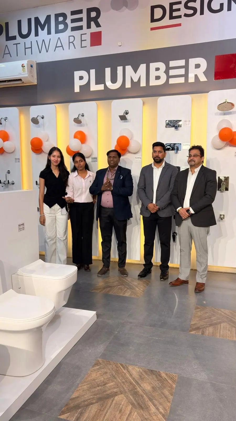Senior Plumber Bathware representatives and The Build Mart team inside the new showroom section