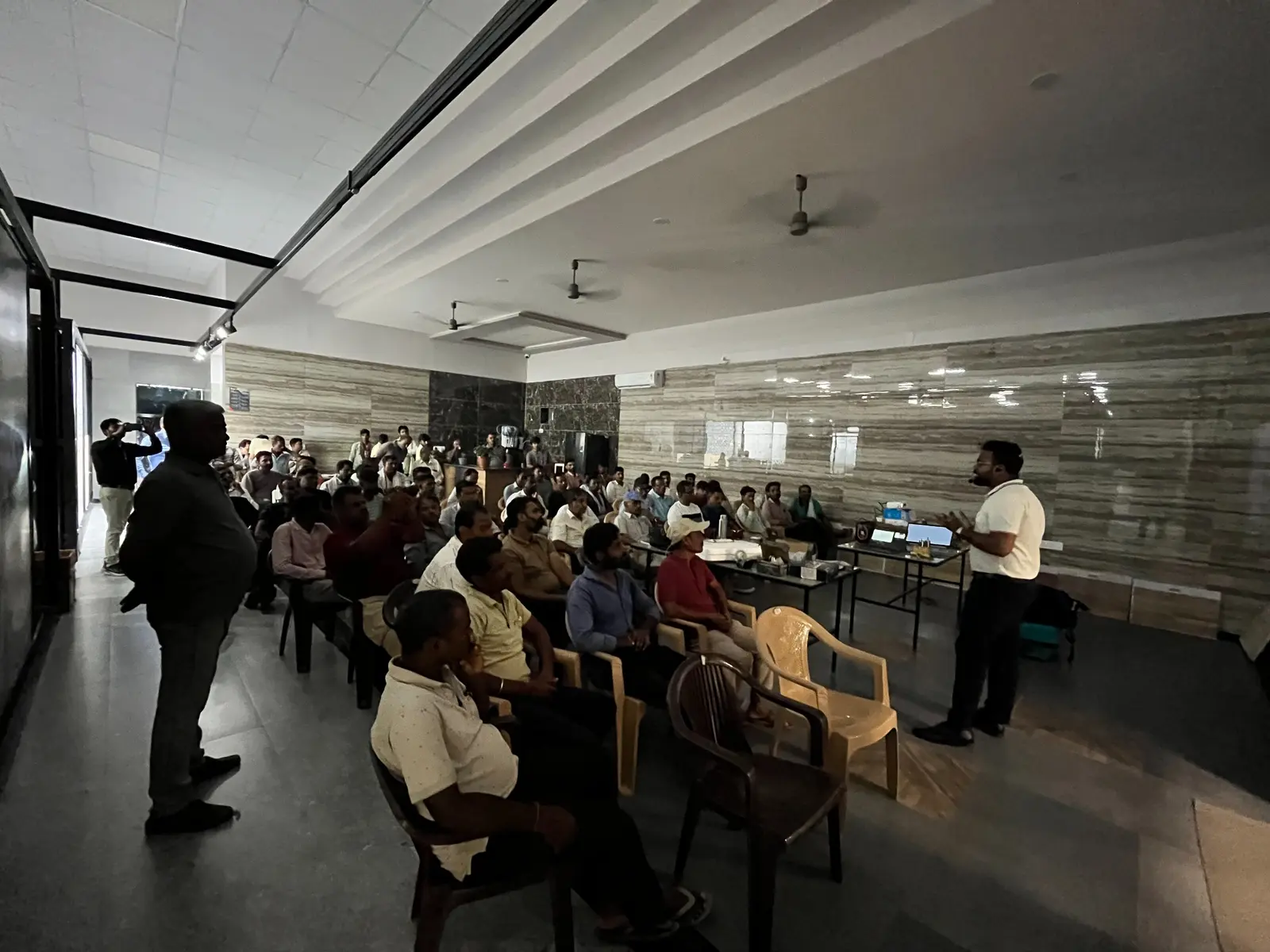 Wide view of plumbers listening to the product presentation at The Build Mart