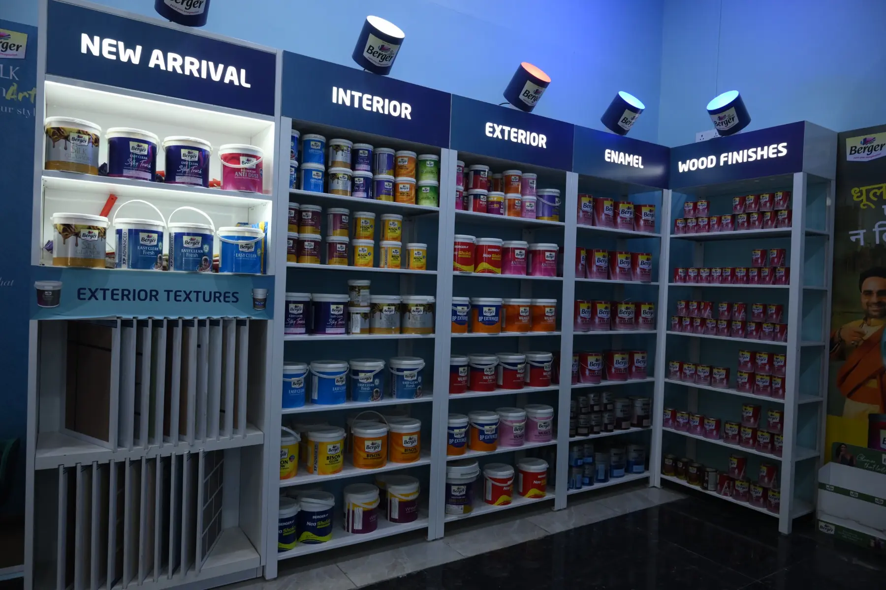 Colourful Berger Paints cans and finish samples arranged in The Build Mart paint studio in Bikaner
