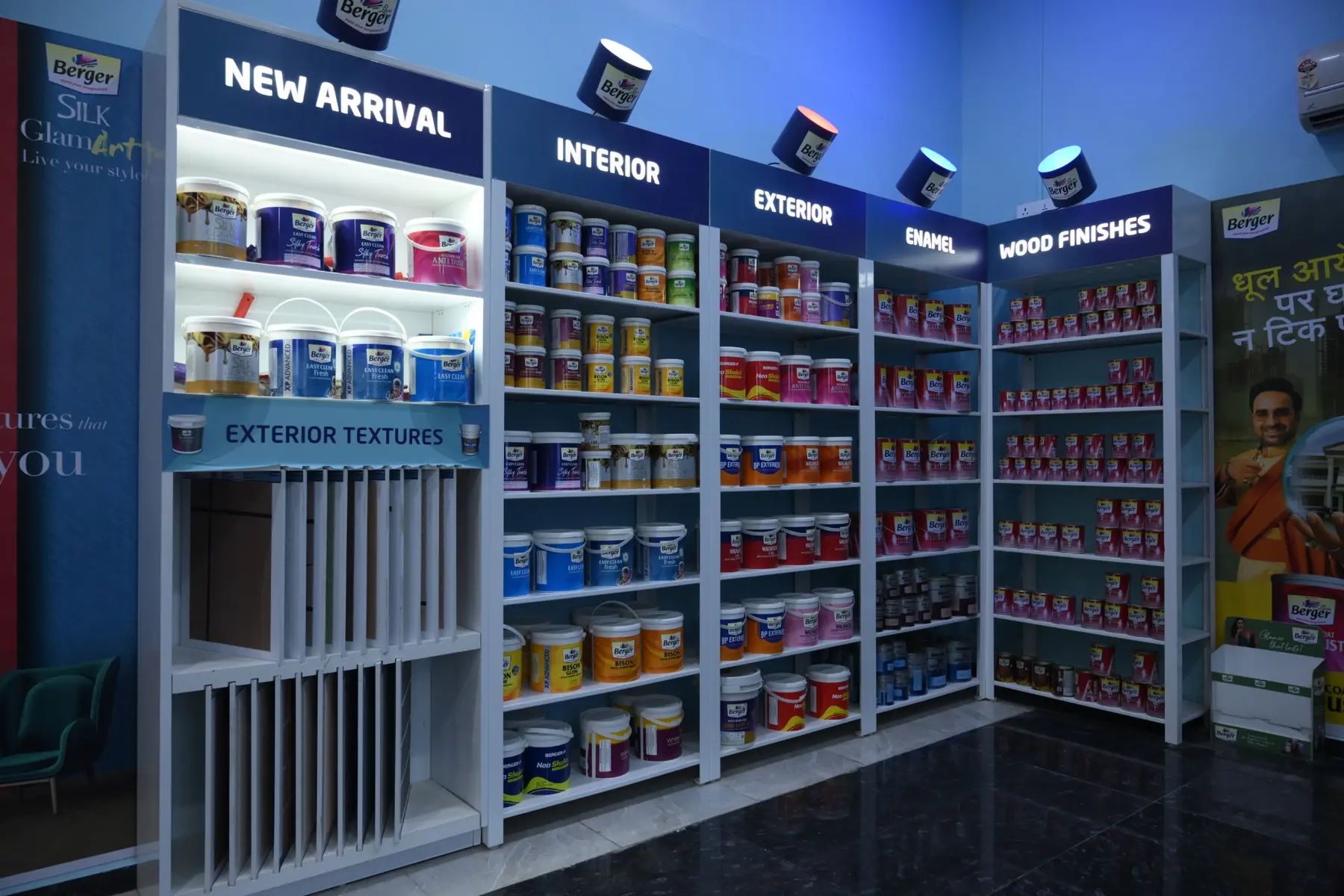 Wide view of Berger Paints product shelves and finish displays inside The Build Mart Bikaner