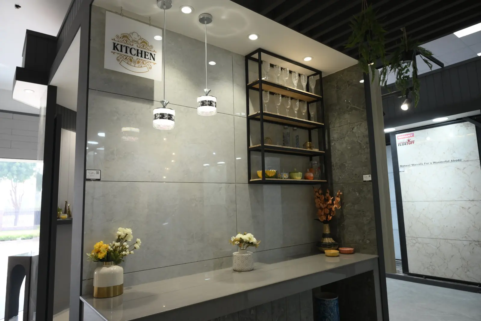 Large-format kitchen tile display with shelves and pendant lights